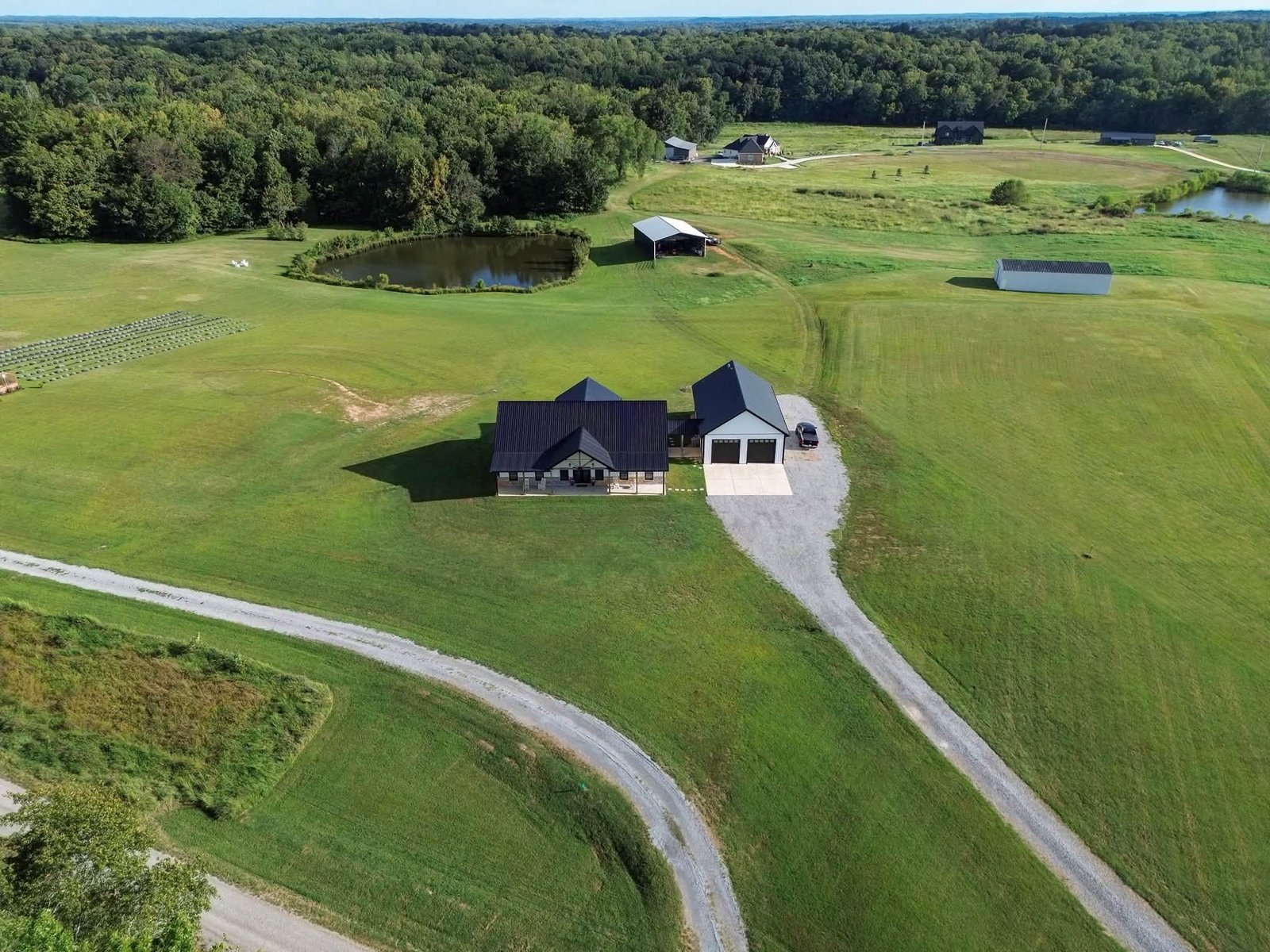 High aerial view of property and surrounding land